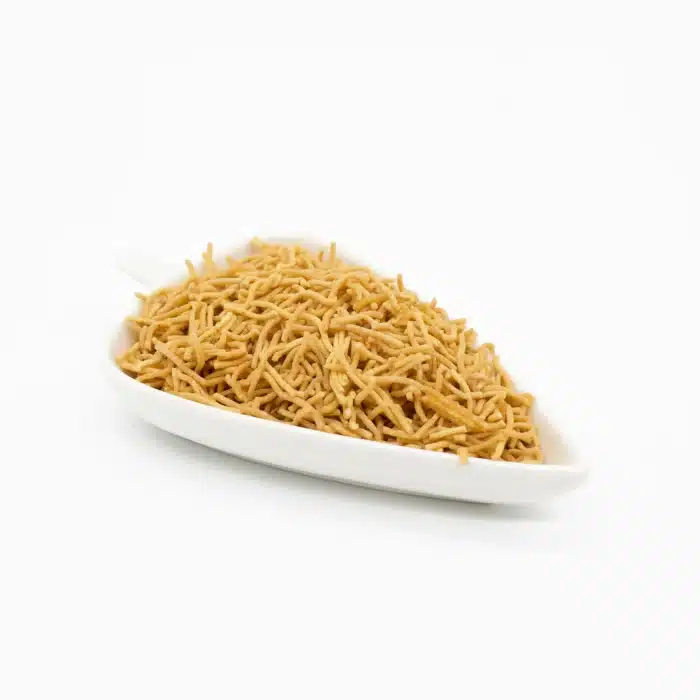 Thikhi Sev - Authentic Indian Snacks in a white ceramic plate